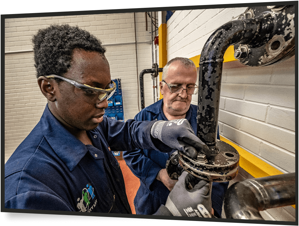 2 men working on a pipe