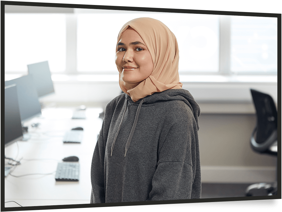 Young woman wearing hijab in office
