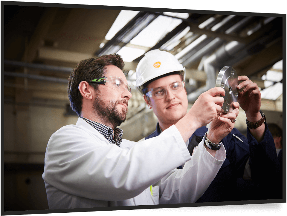 2 men inspecting a mechanical part
