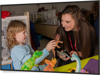 toddler and young woman in a nursery