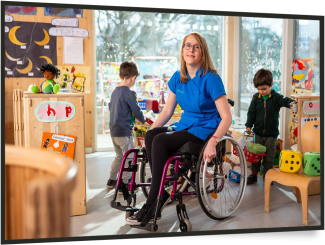 young girl in wheelchair in a nursery