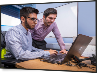 young male and older male looking at computer