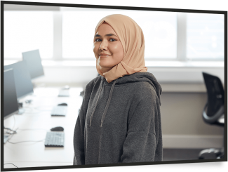 Young woman wearing hijab in office