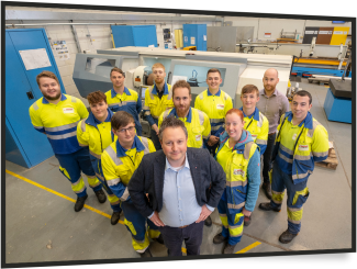 group of male and female engineers looking at camera