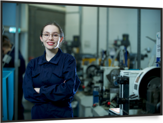 young girl in engineering smiling at camera